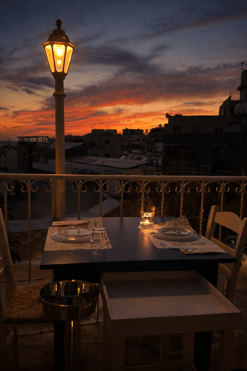 Terrace table at sunset over Paphos