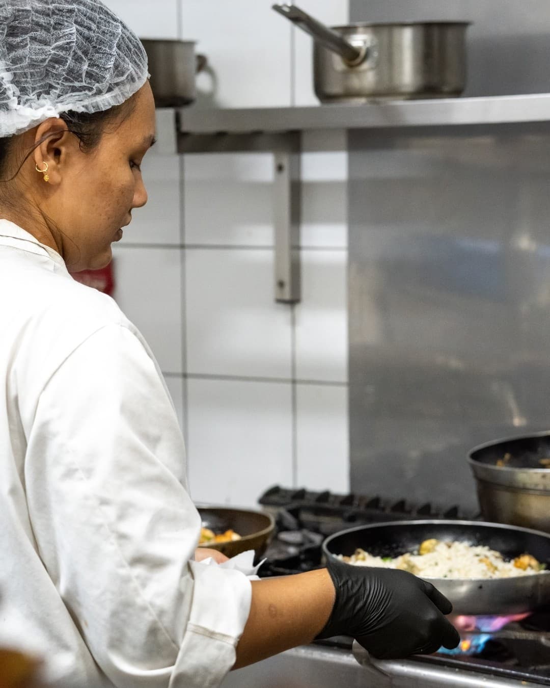 Chef cooking over open flame in the kitchen